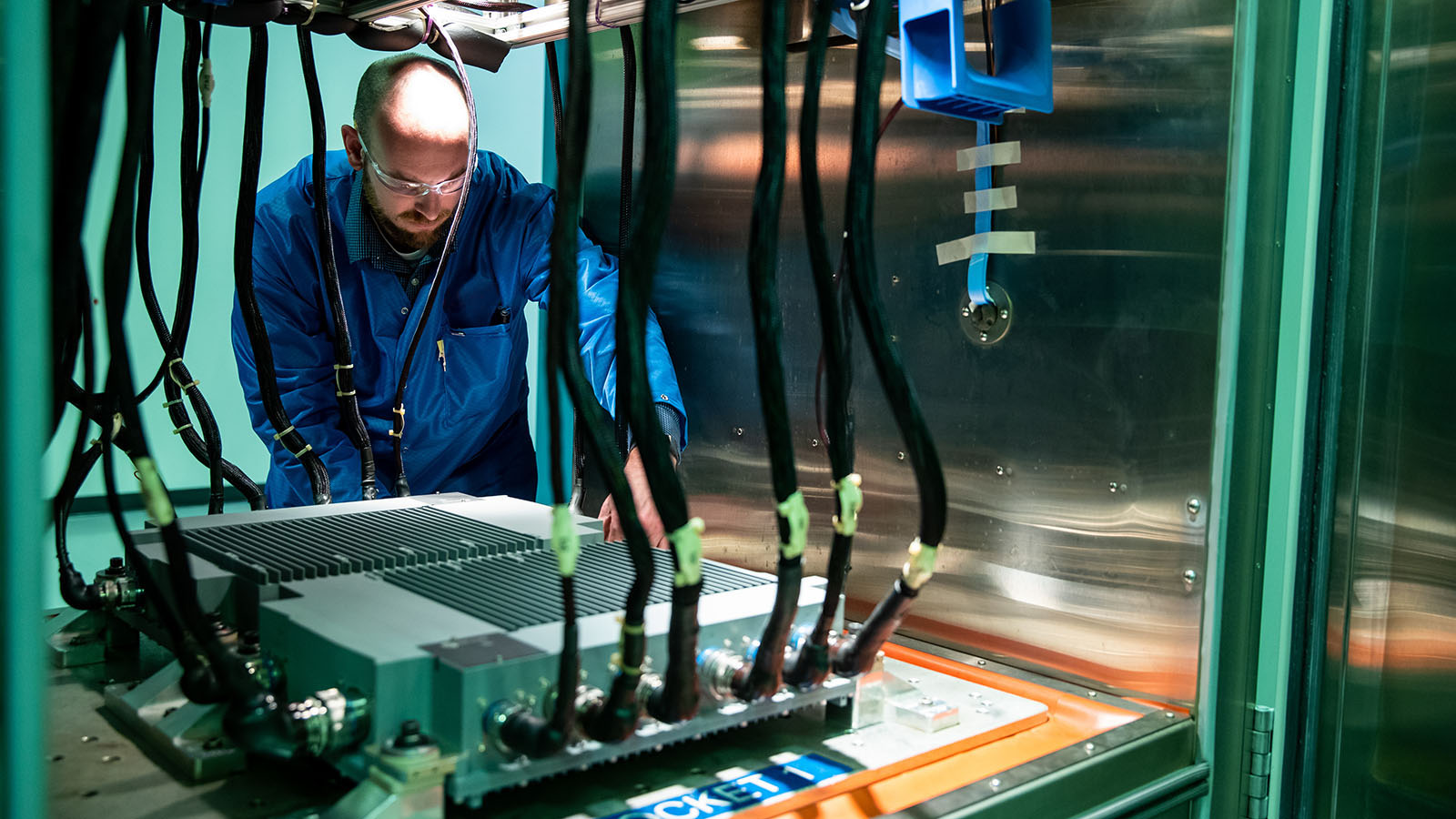 Employee manufacturing an electronic engine controller.